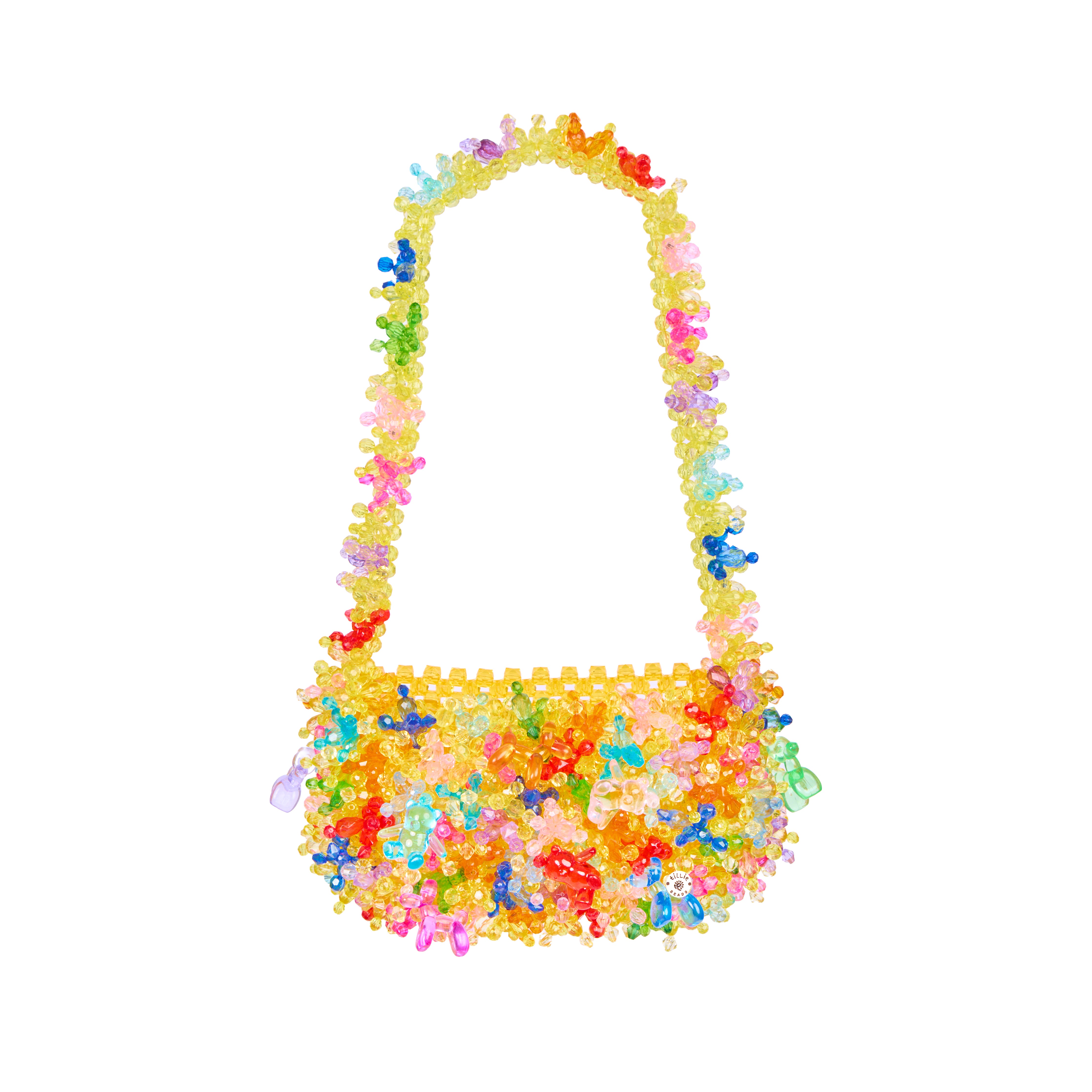 A shoulder bag made of colorful translucent plastic beads and small decorative charms, isolated on a solid white background.